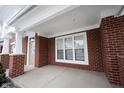 Covered porch features an inviting entrance with brick columns and ample natural light at 15542 Crofton Pl, Westfield, IN 46074