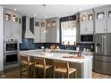 Modern kitchen featuring gray cabinets, a stylish island, and stainless steel appliances at 19840 Chatham Shore Ln, Westfield, IN 46074