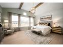 Bright main bedroom featuring large windows, a decorative chandelier, and elegant furnishings at 19868 Chatham Shore Ln, Westfield, IN 46074