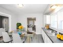 Bright dining area featuring a glass table, stylish seating, and a view into other rooms at 2138 N Dexter St, Indianapolis, IN 46202