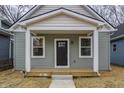 Charming bungalow-style home with a covered front porch, inviting curb appeal, and well-maintained landscaping at 2193 N Dexter St, Indianapolis, IN 46202