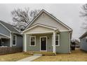 Charming single-story home with a covered porch, manicured lawn, and inviting curb appeal at 2193 N Dexter St, Indianapolis, IN 46202