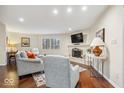 Bright living room with fireplace, hardwood floors, neutral paint, and an abundance of natural light at 2235 Rome Dr # D, Indianapolis, IN 46228