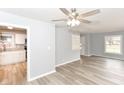 Well-lit living room with new flooring, ceiling fan, open to a remodeled kitchen at 3095 W 69Th St, Indianapolis, IN 46268