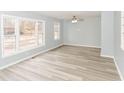 Bright living room featuring new floors, large windows, and a ceiling fan at 3095 W 69Th St, Indianapolis, IN 46268