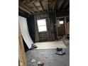 Unfinished room features a window and exposed framing, presenting an opportunity to design a personalized space at 3178 Graceland Ave, Indianapolis, IN 46208