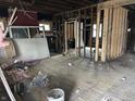 Exposed framing and hardwood floors in a spacious room offering possibilities for modern design and customization at 3178 Graceland Ave, Indianapolis, IN 46208