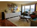 Inviting living room with modern decor, hardwood floors, a large window, and comfortable seating at 3965 N Meridian St # 7D, Indianapolis, IN 46208