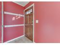 Entryway with red walls and a wooden door with glass panes at 4952 Mathews Ave, Indianapolis, IN 46227