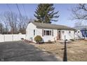 Single story home featuring white siding, a brown front door and a driveway at 4952 Mathews Ave, Indianapolis, IN 46227