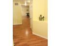 Bright hallway featuring hardwood floors, neutral paint, white trim, and an inviting view into other rooms at 5021 Greenside Dr, Indianapolis, IN 46235