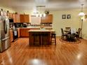 Spacious kitchen with wood cabinets, stainless steel appliances, an island with seating, and an adjacent breakfast nook at 5021 Greenside Dr, Indianapolis, IN 46235