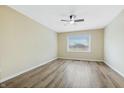 Spacious bedroom with modern flooring, a ceiling fan, and a large window offering plenty of natural light at 5441 E 34Th St, Indianapolis, IN 46218