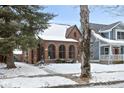 Charming brick home featuring arched windows and mature tree, inviting curb appeal at 5444 Carrollton Ave, Indianapolis, IN 46220
