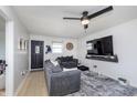 Comfortable living room with neutral walls, a ceiling fan, and a wall-mounted television at 603 W Pearl St, Lebanon, IN 46052