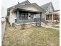 View of charming single-Gathering home with covered porch and well-maintained front yard at 637 N Oakland Ave, Indianapolis, IN 46201