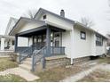 Side view of home featuring a welcoming front porch and traditional architecture at 637 N Oakland Ave, Indianapolis, IN 46201