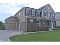 Beautiful home with an attached two car garage, well-maintained lawn, and a charming exterior at 7027 Pinnacle Dr, Columbus, IN 47201