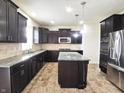 Modern kitchen features granite counters, stainless steel appliances, island, and dark wood cabinetry at 7027 Pinnacle Dr, Columbus, IN 47201