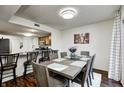Bright dining area with wood table, seating for six, modern lighting, and open access to the kitchen at 7459 Quincy Ct, Indianapolis, IN 46254