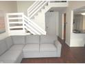 Inviting living room featuring a comfortable sectional sofa and staircase access at 7459 Quincy Ct, Indianapolis, IN 46254