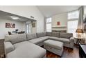Spacious living room featuring a gray sectional sofa, wood floors, and a stone fireplace at 7459 Quincy Ct, Indianapolis, IN 46254