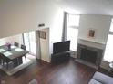 Bright and spacious living room featuring a fireplace, large windows, and dining area at 7459 Quincy Ct, Indianapolis, IN 46254