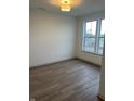 Bright bedroom featuring hardwood floors, white walls, and a large window at 780 James William Ln, Westfield, IN 46074