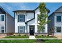 Attractive two-story home with white siding, gray trim, a well-manicured lawn and inviting curb appeal at 780 James William Ln, Westfield, IN 46074