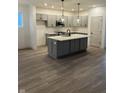 Modern kitchen featuring gray cabinets, a center island, and stainless steel appliances at 780 James William Ln, Westfield, IN 46074