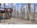 Spacious wooden deck with stairs leading to a serene backyard with mature trees at 8937 W 800 N, Indianapolis, IN 46259