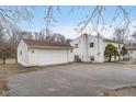 View of the detached garage, and the back exterior of the home at 10483 126Th St, Fishers, IN 46038