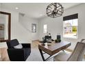 Bright study featuring a stylish desk, modern light fixture and a large window at 11611 Cotterill Way, Indianapolis, IN 46235