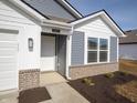 Close up of the front of a single Gathering home, showcasing the address number and small front yard plants at 1244 Fleming Dr, Greenfield, IN 46140