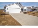 Low angle shot of a single Gathering home with a large driveway and two-car garage at 1244 Fleming Dr, Greenfield, IN 46140