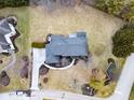Overhead view of a suburban home displays a large lot, mature landscaping, and a well-maintained gray roof at 12878 Mayfair Ln, Carmel, IN 46032
