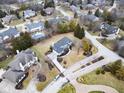 An aerial view of the property in its neighborhood shows mature trees and proximity to other well-maintained homes at 12878 Mayfair Ln, Carmel, IN 46032