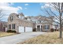Spacious home featuring a three-car garage and a long driveway at 14402 Wolverton Way, Fishers, IN 46037
