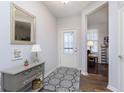Bright entryway with a decorative mirror, table, and a view into the adjacent room at 16613 Grappa Trl, Fishers, IN 46037