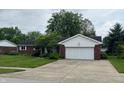 Inviting brick ranch home with attached two-car garage and a well-kept lawn at 1701 Beech N Dr, Plainfield, IN 46168
