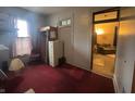 Bedroom space with red carpet, vintage decor, and ample storage at 20 W Elm St, Morgantown, IN 46160