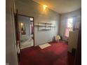 Cozy room with view to the hallway, vintage carpet, and built-in shelves at 20 W Elm St, Morgantown, IN 46160