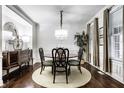 Elegant dining room with a chandelier, hardwood floors, and ample natural light at 2000 Haverford St, Carmel, IN 46032