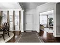Bright foyer featuring hardwood floors, elegant molding, and a view into other rooms at 2000 Haverford St, Carmel, IN 46032