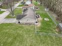 Aerial view of a home with a fenced yard, detached garage, and deck at 2129 Heather Rd, Anderson, IN 46012