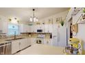 Bright kitchen with white cabinetry, modern appliances, and decorative backsplash at 2129 Heather Rd, Anderson, IN 46012