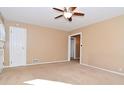 Spacious living room features neutral carpet, ceiling fan and great light at 3533 N Grant Ave, Indianapolis, IN 46218