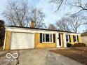 Charming single-story home with a yellow brick facade, attached garage, and well-maintained lawn at 3656 Allison Ave, Indianapolis, IN 46224