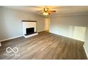 Bright living room features a decorative fireplace, sleek floors, and neutral paint, creating a serene atmosphere at 3656 Allison Ave, Indianapolis, IN 46224