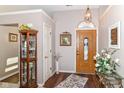 Inviting foyer featuring a decorative front door, stylish decor, and hardwood flooring at 5550 Crystal Bay W Dr, Plainfield, IN 46168